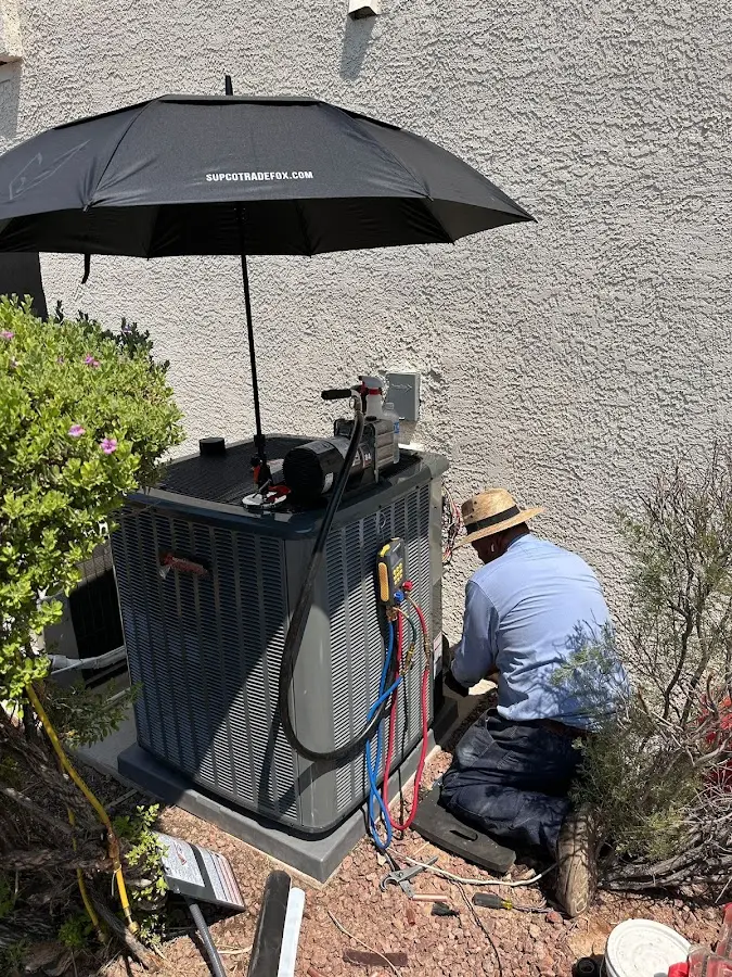 HVAC technician performing outdoor AC maintenance in Sioux City